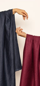 Nouvelle collection Atelier Brunette : tissus bleu marine et bordeaux tenus à bout de bras