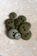 Close-up of the same buttons on the edge of a marbled beige stone.