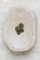 Another close-up of the buttons on the marbled beige stone, from a different angle.