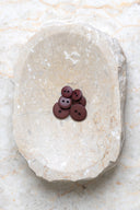 Close-up of the same buttons on the edge of a marbled beige stone.