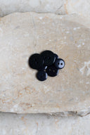 Close-up of the same buttons on the edge of a marbled beige stone.