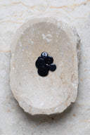 Top-down view of the buttons, stacked at the centre of a marbled beige stone.