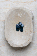 Top-down view of the buttons, stacked at the centre of a marbled beige stone.