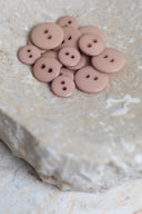 Another close-up of the buttons on the marbled beige stone, from a different angle.