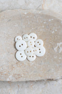 Close-up of the same buttons on the edge of a marbled beige stone.