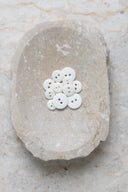Another close-up of the buttons on the marbled beige stone, from a different angle.