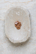 Close-up of the same buttons on the edge of a marbled beige stone.