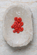 Close-up of the same buttons on the edge of a marbled beige stone.