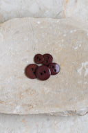 Close-up of the same buttons on the edge of a marbled beige stone.