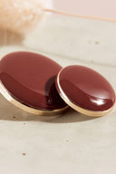 Extreme macro close-up of the buttons, with a blurred background evoking the floral styling.