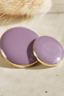 Extreme macro close-up of the buttons, with a blurred background evoking the floral styling of the scene.