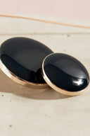 Extreme macro close-up of the buttons, with a blurred background evoking the floral styling.