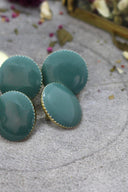 Close-up of the faceted buttons, showing the gold trim and the metal shank fastening on the back.