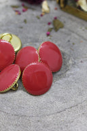 Same set of faceted terracotta Gem buttons with a gold trim, viewed from a different close-up angle, revealing the gold sewing shank ring on the back of one button.