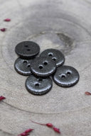 Close-up of the fully glittered buttons, highlighting the sparkling texture of the finish.