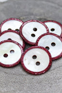Close-up of the pearly white buttons with a glittery trim, highlighting the sparkle around the edge.