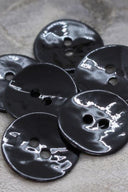 Close-up of the same glossy enamel buttons, revealing the smooth texture and shine of the material.