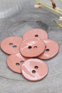 Close-up of the same glossy enamel buttons, revealing the smooth texture and shine of the material.