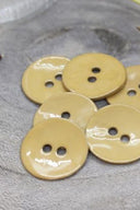 Close-up of the same glossy enamel buttons, revealing the smooth texture and shine of the material.