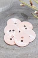 Close-up of the same glossy enamel buttons, revealing the smooth texture and shine of the material.