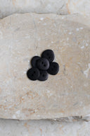 Close-up of the same buttons on the edge of a marbled beige stone.