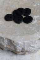 Another close-up view of the buttons on the marbled beige stone, from a different angle.