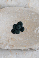 Close-up of the same buttons on the edge of a marbled beige stone.