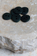 Another close-up view of the buttons on the marbled beige stone, from a different angle.