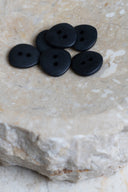 Close-up of the same buttons on the edge of a marbled beige stone.