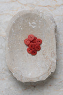Close-up of the same buttons on the edge of a marbled beige stone.