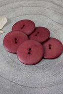 Close-up of the same buttons on the edge of a marbled beige stone.