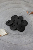 Close-up of the same buttons on the edge of a marbled beige stone.