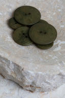 Another close-up of the buttons on the marbled beige stone, from a different angle.