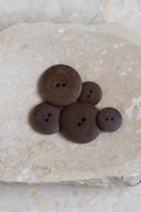 Another close-up view of the buttons on the marbled beige stone, from a different angle.