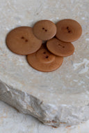 Another close-up of the buttons on the marbled beige stone, from a different angle.