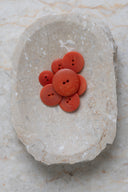 Close-up of the same buttons on the edge of a marbled beige stone.