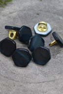 Close-up of the buttons shown from behind, revealing the gold-tone metal shank fastening.