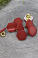 Close-up of the buttons shown from the back, revealing the gold metal shank fastening.