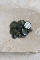 Close-up of the same buttons on the edge of a marbled beige stone.