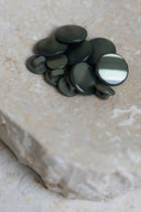 Another close-up view of the buttons on the marbled beige stone, from a different angle.