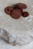 Close-up of the same buttons on the edge of a marbled beige stone.