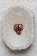 Another close-up view of the buttons on the marbled beige stone, from a different angle.
