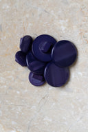 Close-up of the same buttons on the edge of a marbled beige stone.