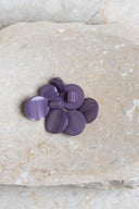 Close-up of the same buttons on the edge of a marbled beige stone.