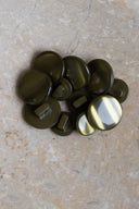 Close-up of the same buttons on the edge of a marbled beige stone.