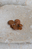 Close-up of the same buttons on the edge of a marbled beige stone.