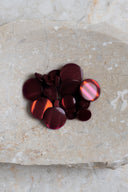 Close-up of the same buttons on the edge of a marbled beige stone.