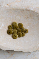 Close-up of the same buttons on the edge of a marbled beige stone.