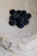Another close-up view of the buttons on the marbled beige stone, from a different angle.