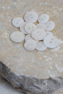 Another close-up view of the buttons on the marbled beige stone, from a different angle.